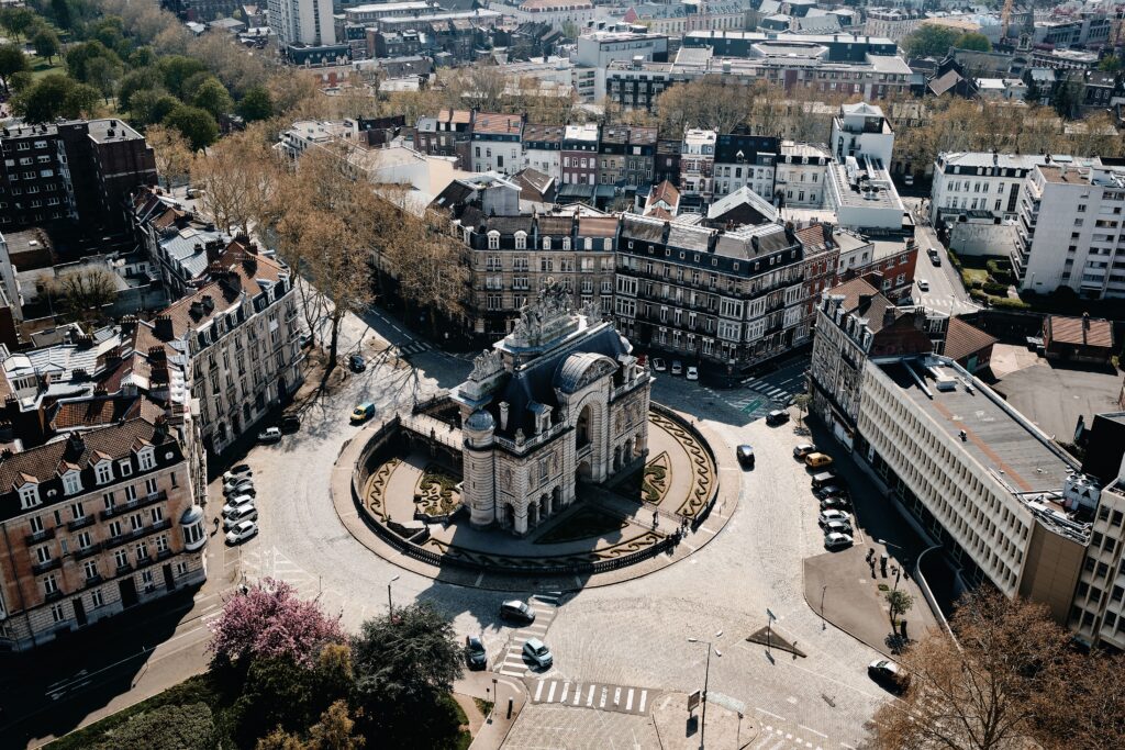 An aerial shot of a cityscape with a lot of cars and beautiful buildings in Lille, France